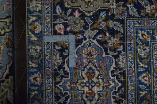 Backside of handmade 2000s Kashan rug showing knot structure and weave density