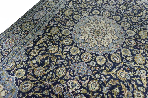Backside of handmade 2000s Kashan rug showing knot structure and weave density