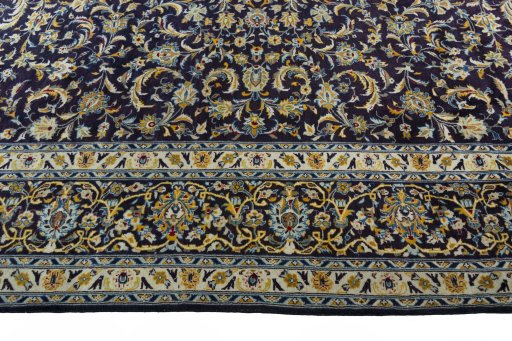 Corner detail of 2000s Kashan rug showing border pattern and Wool pile