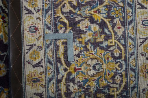 Backside of handmade 2000s Kashan rug showing knot structure and weave density