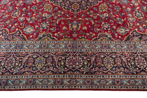 Corner detail of 2000s Kashan rug showing border pattern and Wool pile