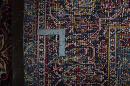 Backside of handmade 2000s Kashan rug showing knot structure and weave density