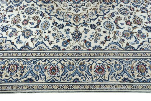Corner detail of 2000s Kashan rug showing border pattern and Wool pile