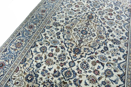 Backside of handmade 2000s Kashan rug showing knot structure and weave density