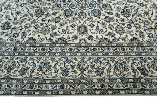 Corner detail of 2000s Kashan rug showing border pattern and Wool pile