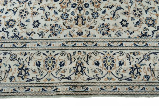 Corner detail of 2000s Kashan rug showing border pattern and Wool pile