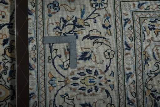 Backside of handmade 2000s Kashan rug showing knot structure and weave density