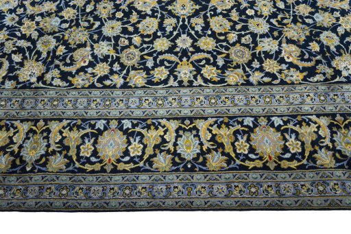 Corner detail of 2000s Kashan rug showing border pattern and Wool pile