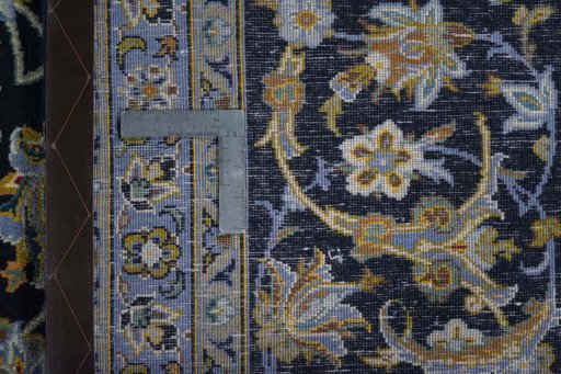 Backside of handmade 2000s Kashan rug showing knot structure and weave density