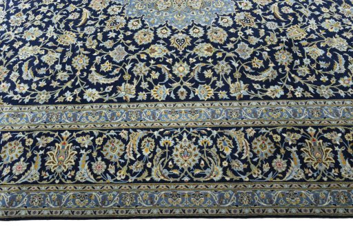 Corner detail of 2000s Kashan rug showing border pattern and Cork pile