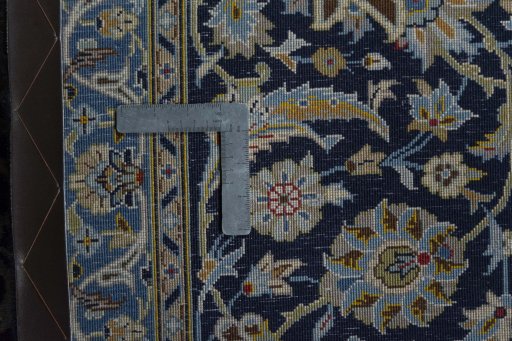 Backside of handmade 2000s Kashan rug showing knot structure and weave density