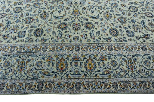 Corner detail of 2000s Kashan rug showing border pattern and Wool pile