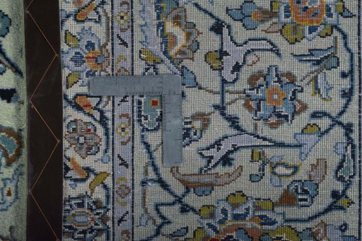 Backside of handmade 2000s Kashan rug showing knot structure and weave density