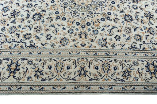 Corner detail of 2000s Kashan rug showing border pattern and Wool pile