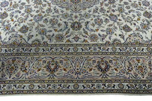 Corner detail of 2000s Kashan rug showing border pattern and Wool pile