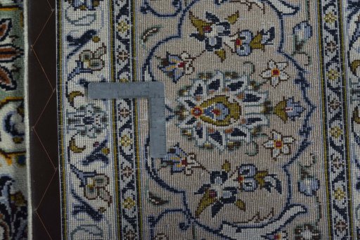 Backside of handmade 2000s Kashan rug showing knot structure and weave density