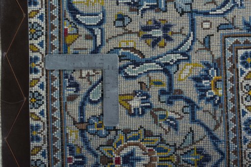 Backside of handmade 2000s Kashan rug showing knot structure and weave density