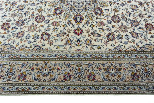 Corner detail of 2000s Kashan rug showing border pattern and Wool pile