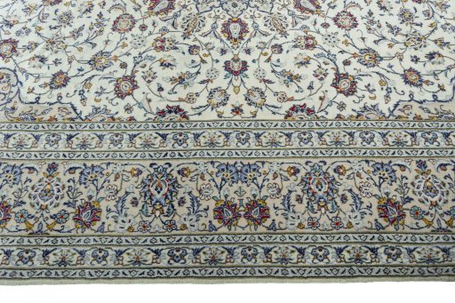 Corner detail of 2000s Kashan rug showing border pattern and Wool pile
