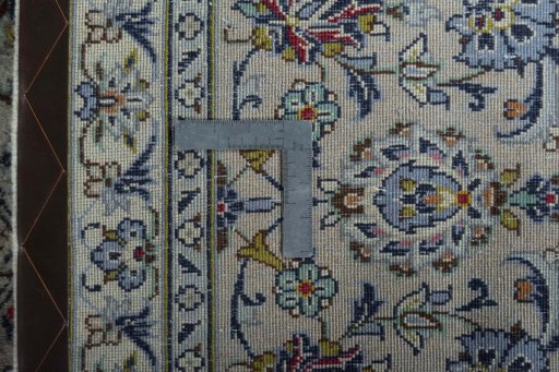 Backside of handmade 2000s Kashan rug showing knot structure and weave density