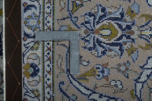 Backside of handmade 2000s Kashan rug showing knot structure and weave density