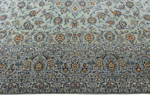 Corner detail of 2000s Kashan rug showing border pattern and Wool pile