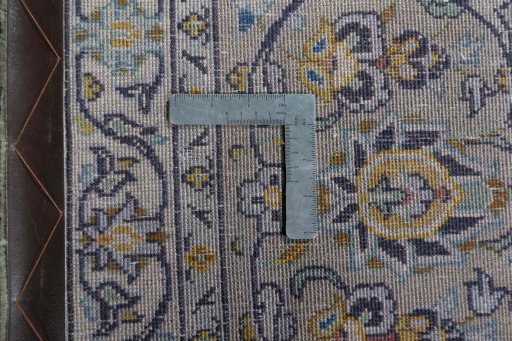 Backside of handmade 2000s Kashan rug showing knot structure and weave density