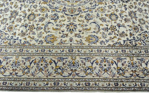 Corner detail of 2000s Kashan rug showing border pattern and Wool pile
