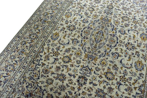 Backside of handmade 2000s Kashan rug showing knot structure and weave density
