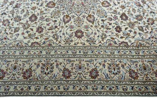 Corner detail of 2000s Kashan rug showing border pattern and Wool pile