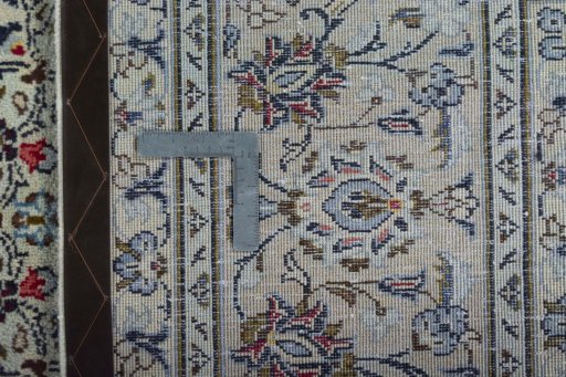 Backside of handmade 2000s Kashan rug showing knot structure and weave density