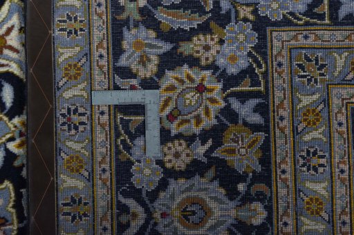 Backside of handmade 2000s Kashan rug showing knot structure and weave density