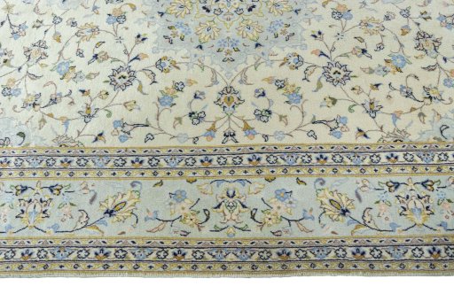 Corner detail of 2000s Kashan rug showing border pattern and Wool pile