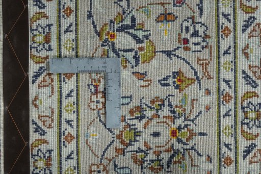 Backside of handmade 2000s Kashan rug showing knot structure and weave density