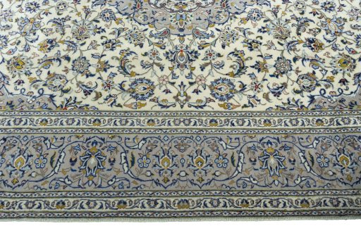 Corner detail of 2000s Kashan rug showing border pattern and Wool pile