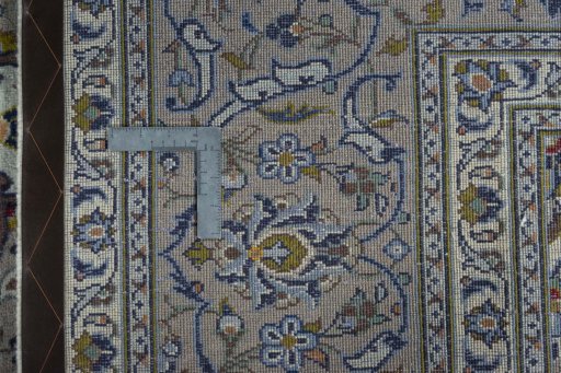 Backside of handmade 2000s Kashan rug showing knot structure and weave density