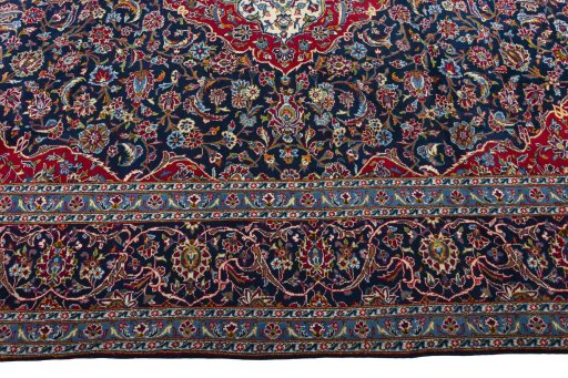 Corner detail of 2000s Kashan rug showing border pattern and Wool pile