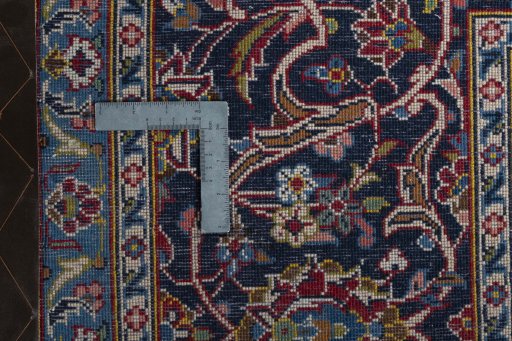 Backside of handmade 2000s Kashan rug showing knot structure and weave density