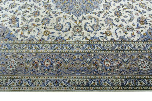 Corner detail of 2000s Kashan rug showing border pattern and Wool pile