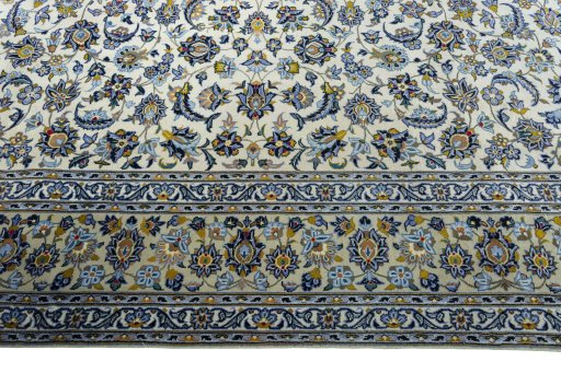 Corner detail of 2000s Kashan rug showing border pattern and Wool pile