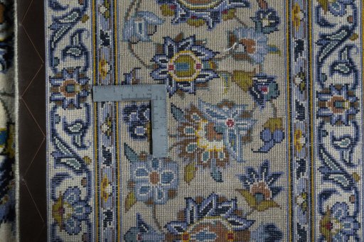 Backside of handmade 2000s Kashan rug showing knot structure and weave density