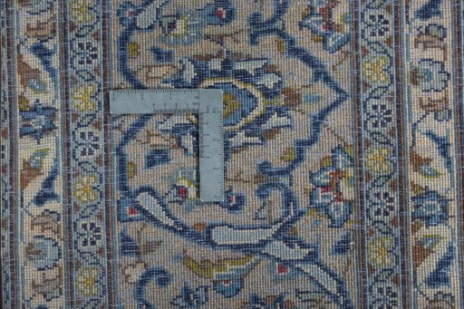 Backside of handmade 2000s Kashan rug showing knot structure and weave density
