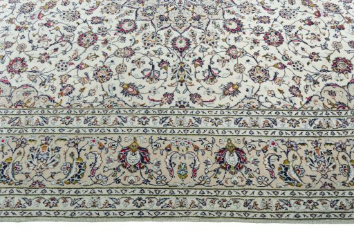 Corner detail of 2000s Kashan rug showing border pattern and Wool pile