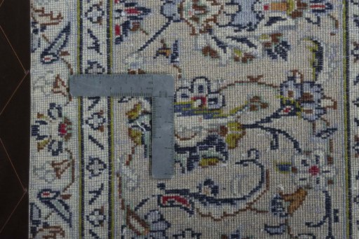 Backside of handmade 2000s Kashan rug showing knot structure and weave density