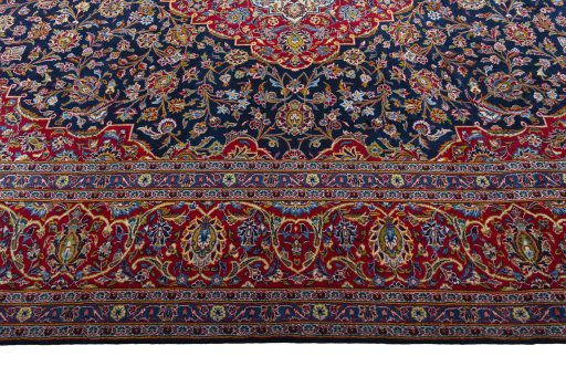 Corner detail of 2000s Kashan rug showing border pattern and Wool pile