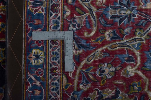 Backside of handmade 2000s Kashan rug showing knot structure and weave density