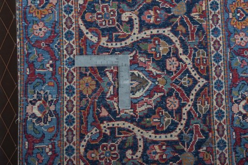 Backside of handmade 1930s Kashan rug showing knot structure and weave density
