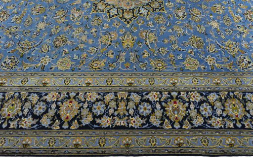 Corner detail of 2000s Kashan rug showing border pattern and Wool pile