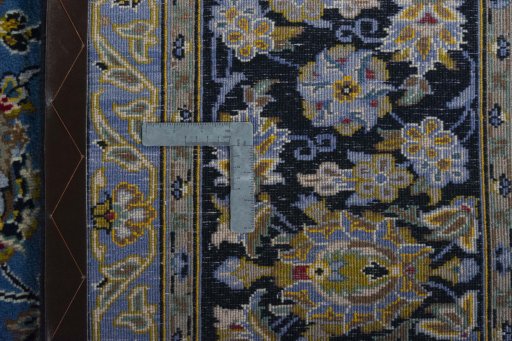 Backside of handmade 2000s Kashan rug showing knot structure and weave density