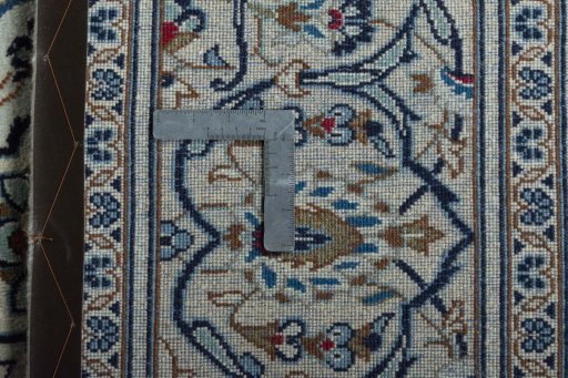 Backside of handmade 2000s Kashan rug showing knot structure and weave density